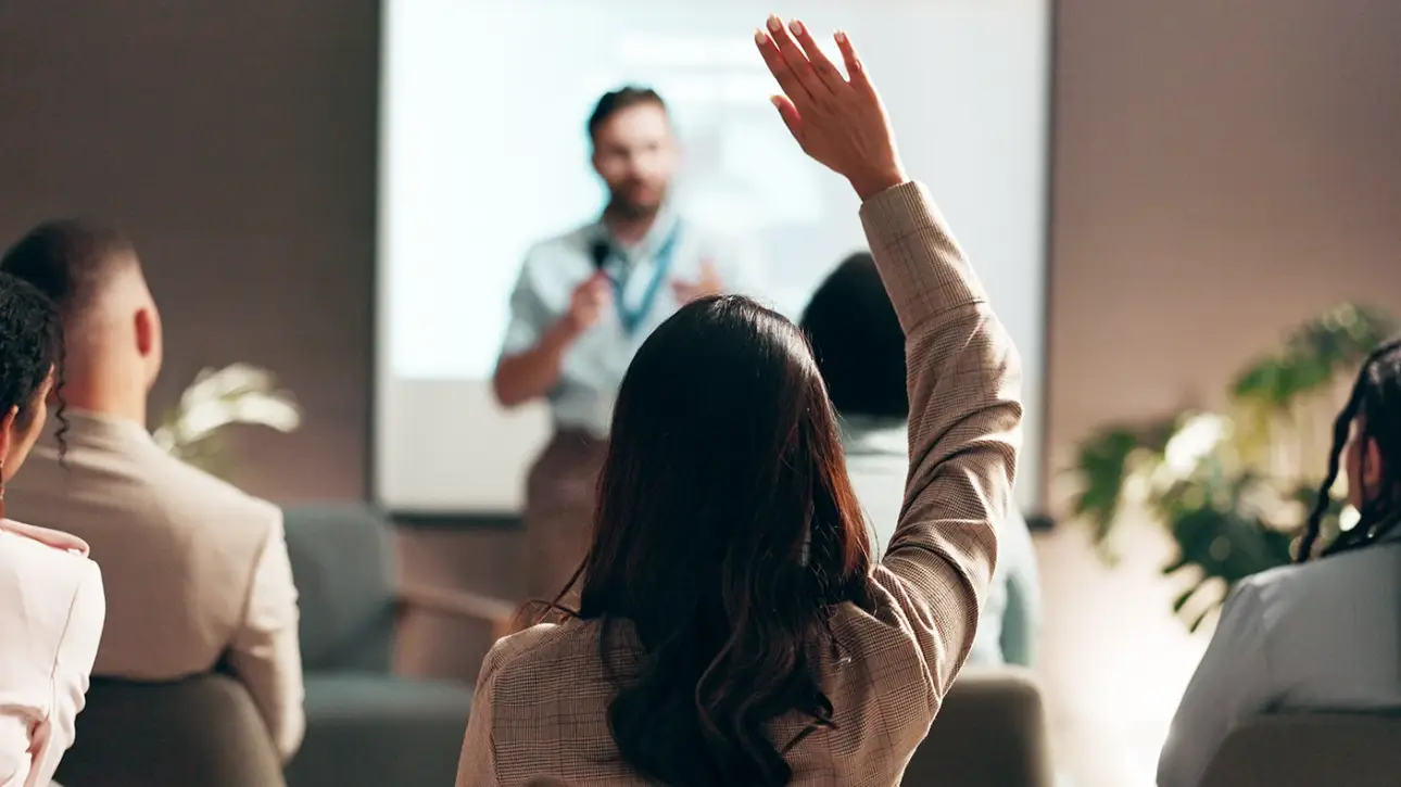 employee raises her hand to take part in environmental education training